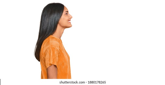 Young Brunette Arab Woman Wearing Casual Clothes Looking To Side, Relax Profile Pose With Natural Face With Confident Smile. 