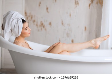Young brunette, european woman treats herself to a comforting warm aroma bath, release tension, gets free her body of the everyday strains and stress