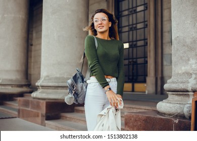 Young Brunette Girl In Black Standing Outside And Watching The Sunset In The City, The Sun Shines Brightly, Fashionable Clothes On A Girl, Hipster Style,, Tattoo, Street Photo, Mood, Freedom, New York