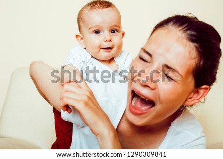 young brunette happy mother holding toddler baby son, breast-feeding concept, lifestyle modern people kissing