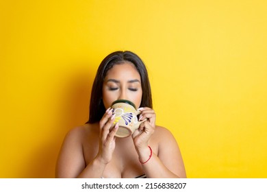 Young Brunette Hispanic Woman Drinking Coffee In Traditional Mexican Cup