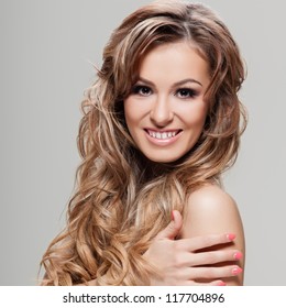 Young Brunette Lady With A Beautiful Hair On Gray Background