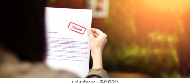 Young brunette long hair girl cries hysterically after being denied a mortgage loan.Depressive sad state female millenial holding  rejection document copy space banner - Shutterstock ID 2197207577