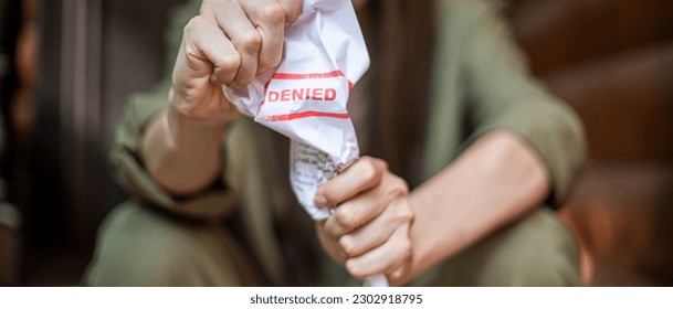 Young brunette long hair girl cries hysterically after being denied a mortgage loan. Depressive sad eviction female millenial holding rejection document copy space banner - Shutterstock ID 2302918795