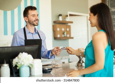 Young Brunette Paying With A Credit Card At The Cash Register In A Cake Shop