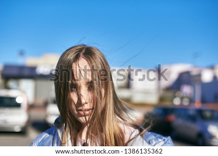 Young blonde woman in a sunny day in the city