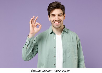 Young Brunette Smiling Happy Caucasian Man 20s Years Old Wearing Casual Mint Shirt White T-shirt Show Ok Okay Gesture Isolated On Purple Violet Background Studio Portrait. People Lifestyle Concept.