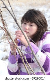 Young brunette teen playing in the field after the snowfall