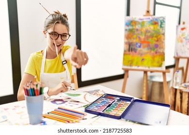 Young Brunette Teenager At Art Studio Pointing Displeased And Frustrated To The Camera, Angry And Furious With You 