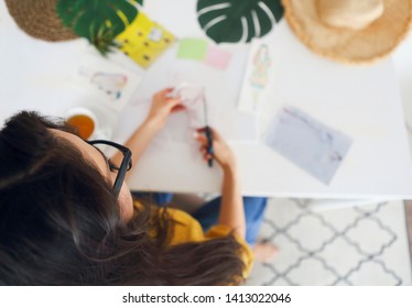 Young Brunette Woman Creating Her Feng Shui Wish Map Using Scissors