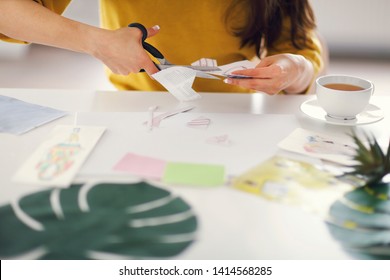 Young Brunette Woman Creating Her Feng Shui Wish Map Using Scissors