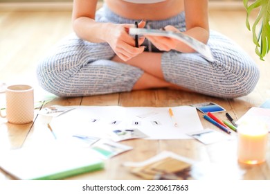 Young brunette woman creating her Feng Shui wish map using scissors. Dreams and wishes - Shutterstock ID 2230617863