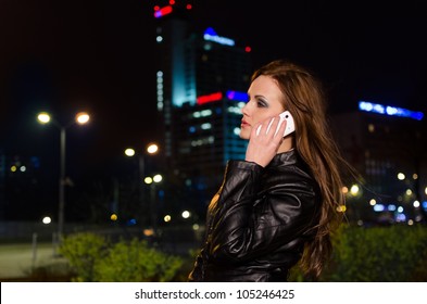 Young Brunette Woman During Phone Call In The City Centre At Night