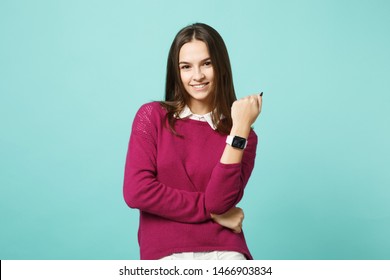 Young brunette woman girl in casual clothes posing isolated on blue green turquoise wall background studio portrait. People sincere emotions lifestyle concept. Mock up copy space. smart watch on hand - Powered by Shutterstock