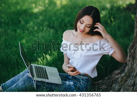 Young brunette woman, girl working with laptop, tablet and phone