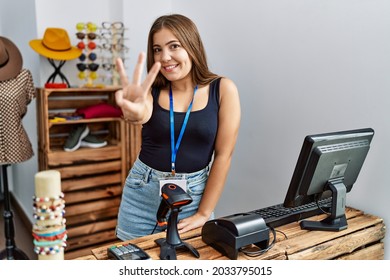 Young Brunette Woman Holding Banner With Open Text At Retail Shop Showing And Pointing Up With Fingers Number Three While Smiling Confident And Happy. 