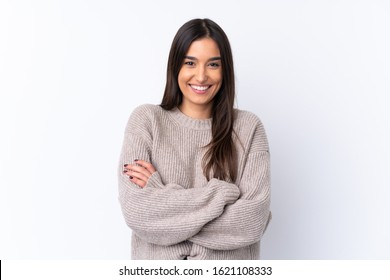 Young brunette woman over isolated white background keeping the arms crossed in frontal position - Shutterstock ID 1621108333