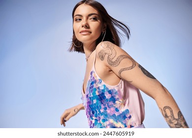 A young brunette woman showcasing a tattoo on her arm in a stylish studio setting. - Powered by Shutterstock