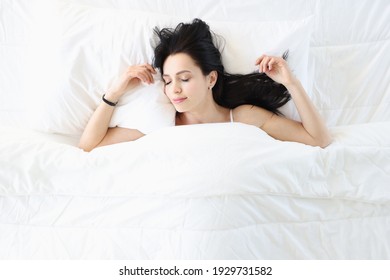 Young Brunette Woman Sleeping In White Bed Top View. Healthy Sleep Concept