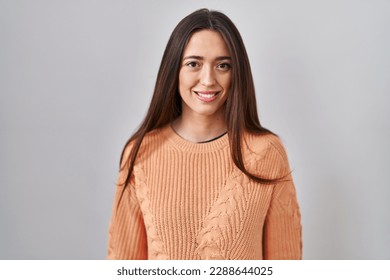 Young brunette woman standing over white background with a happy and cool smile on face. lucky person.  - Shutterstock ID 2288644025