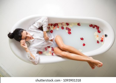 A Young Brunette Woman Takes A Milk Bath.