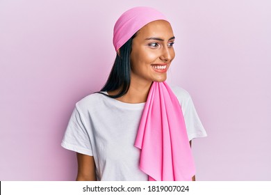 Young Brunette Woman Wearing Breast Cancer Support Pink Scarf Looking Away To Side With Smile On Face, Natural Expression. Laughing Confident. 