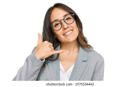 Young Brunette Woman Wearing Business Clothes Smiling Doing Phone Gesture With Hand And Fingers Like Talking On The Telephone. Communicating Concepts. 