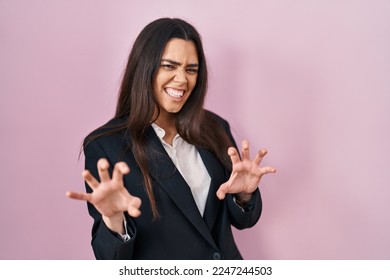 Young brunette woman wearing business style over pink background smiling funny doing claw gesture as cat, aggressive and sexy expression  - Shutterstock ID 2247244503