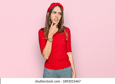 Young brunette woman wearing casual clothes thinking worried about a question, concerned and nervous with hand on chin 