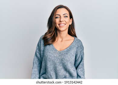 Young brunette woman wearing casual winter sweater with a happy and cool smile on face. lucky person. 