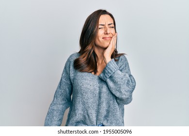 Young Brunette Woman Wearing Casual Winter Sweater Touching Mouth With Hand With Painful Expression Because Of Toothache Or Dental Illness On Teeth. Dentist 