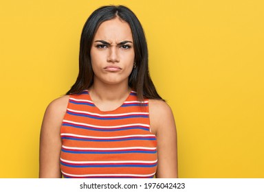 Young brunette woman wearing casual clothes skeptic and nervous, frowning upset because of problem. negative person.  - Shutterstock ID 1976042423
