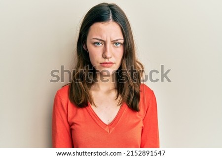 Young brunette woman wearing casual clothes depressed and worry for distress, crying angry and afraid. sad expression. 