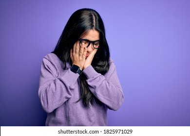 Young Brunette Woman Wearing Glasses Over Purple Isolated Background With Sad Expression Covering Face With Hands While Crying. Depression Concept.