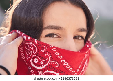 Young Brunette Woman Wearing Red Bandana Covering Half Of Face, Looking At Camera, Activist Protest Concept.