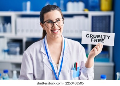 Young brunette woman working on cruelty free laboratory looking positive and happy standing and smiling with a confident smile showing teeth  - Shutterstock ID 2253438505