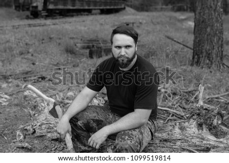 Similar – Foto Bild bärtiger Jäger, der auf der Wurzel eines trockenen Baumes sitzt.