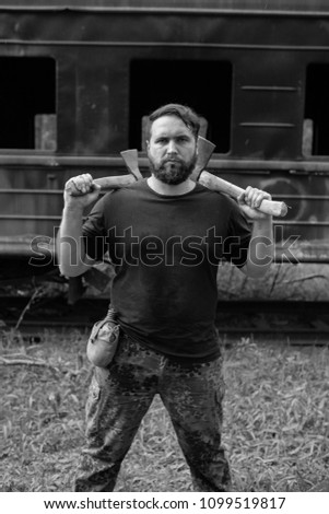 Similar – Image, Stock Photo bearded man huntsman with two axes stands near a rusty train