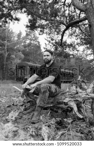 Similar – Foto Bild bärtiger Holzfäller mit einer Axt, die neben einem rostigen Zug sitzt.