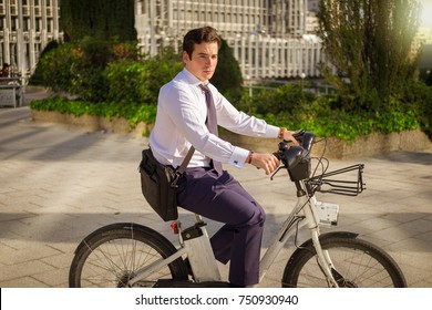 Young Buinessman Riding A Bicycle To Work In The City.