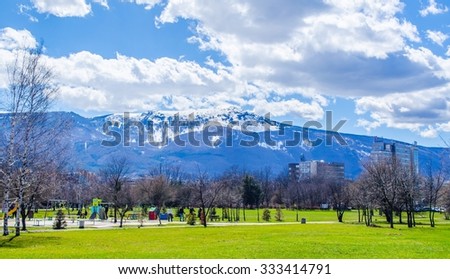 young bulgarians are walking through park in student city in sofia with vitosha mountain on background.
