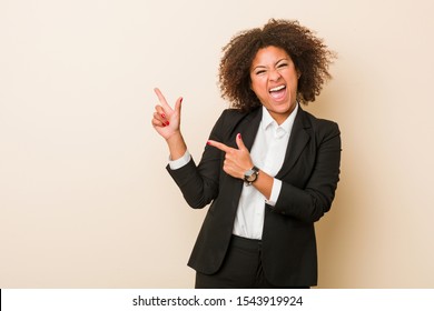 Young Business African American Woman Pointing With Forefingers To A Copy Space, Expressing Excitement And Desire.