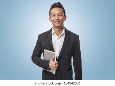 Young Business Asian Man Using His Tablet