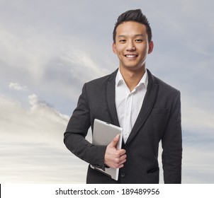 Young Business Asian Man Using His Tablet