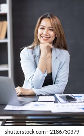 Young Business Asian Woman Working On Laptop Computer In Modern Office. Doing Finances, Accounting Analysis, Report Data Pointing Graph Freelance Education And Technology Concept.