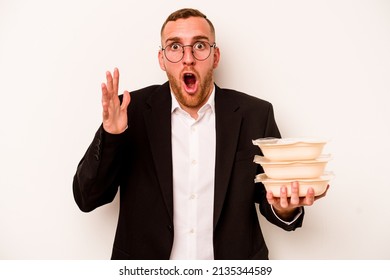 Young Business Caucasian Man Holding Tupperware Isolated On White Background Surprised And Shocked.