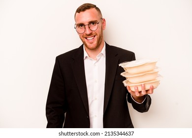 Young Business Caucasian Man Holding Tupperware Isolated On White Background Laughing And Having Fun.