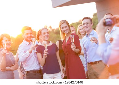 Young Business Colleagues Talking While Standing At Rooftop During Party