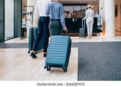 A Young Business Couple Arrives At The Hotel And Goes To The Front Desk To Check In.