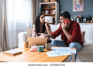 Young business couple freelance workers, small startup company owners, colleagues working at home, having bad slow internet connection, calling internet provider to complain about low connectivity. - Powered by Shutterstock